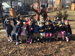 Pre-Schoolers gathered around a tree